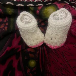 Hand knitted white pink trimmed baby bootie